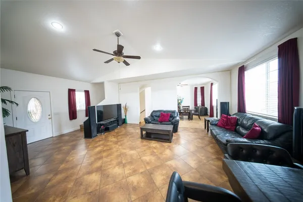 a living room with furniture and a chandelier