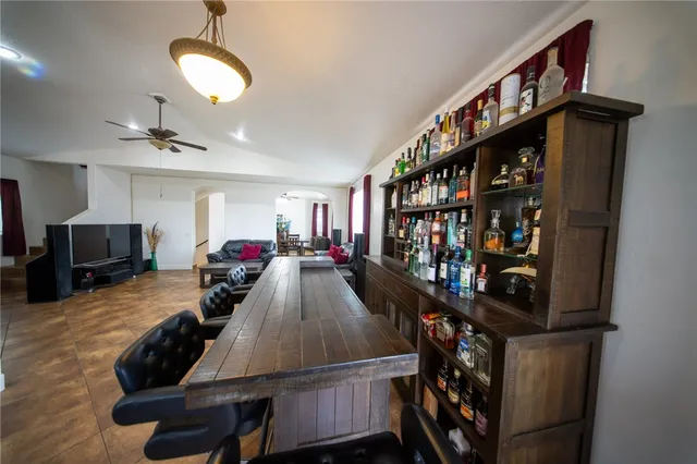 a living room with furniture a window and bookshelf