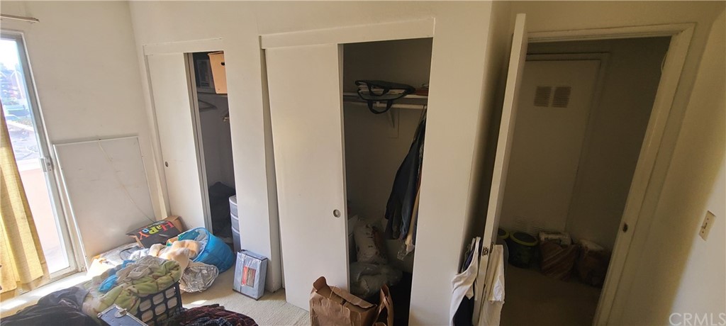 1192 Mitchell Avenue, Unit 7 Tustin, CA 92780 - Photo 12 of 16 a view of walk in closet with clothes and shoes