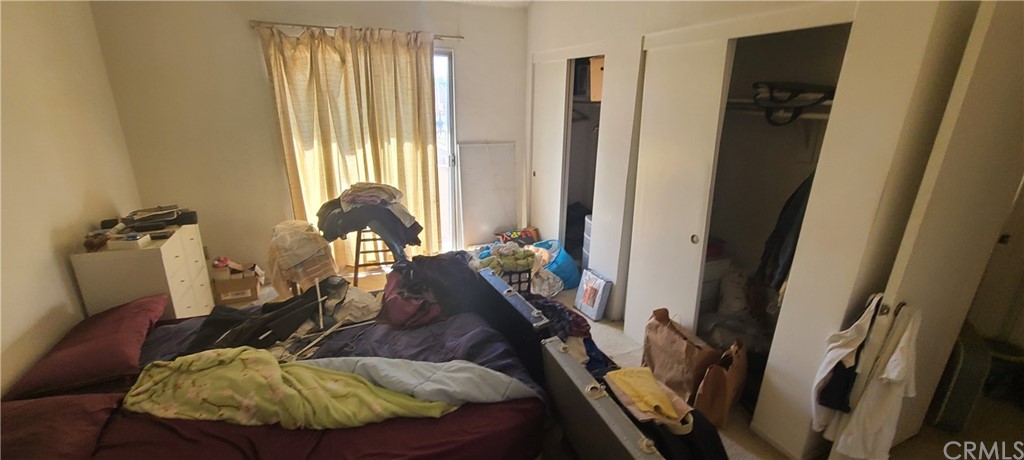 1192 Mitchell Avenue, Unit 7 Tustin, CA 92780 - Photo 13 of 16 a bed room with a bed and a chair