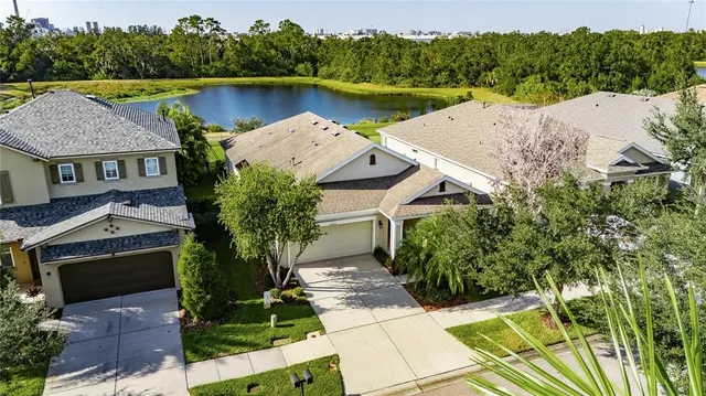 an aerial view of house with yard and ocean view