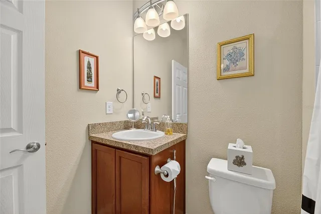 a bathroom with a granite countertop sink a mirror and a shower
