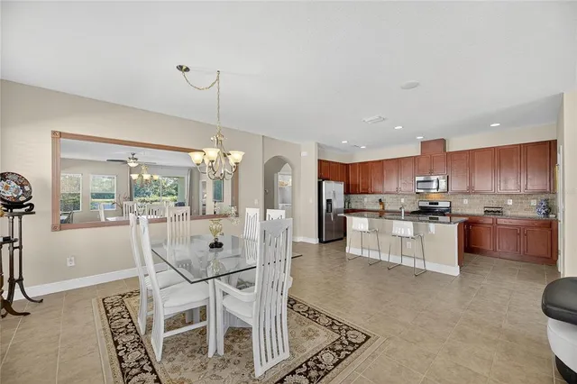 a front view of a house with a yard and palm trees