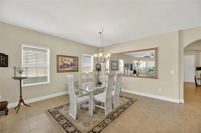 an aerial view of a house with garden space and a pond
