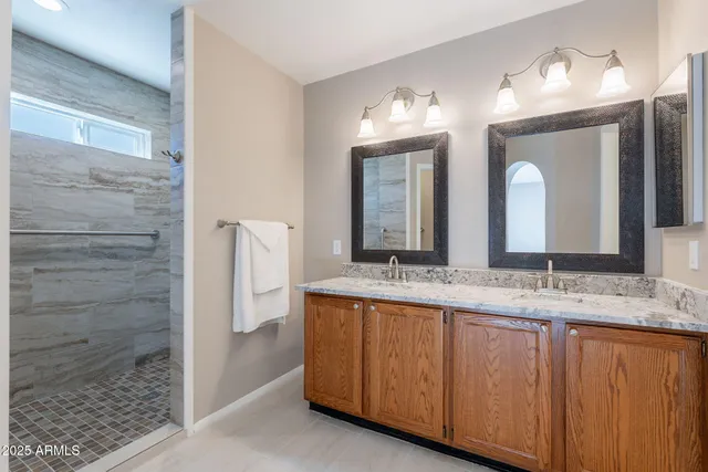 a bathroom with a double vanity sink and a mirror