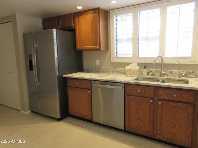 a kitchen with a sink a window and refrigerator