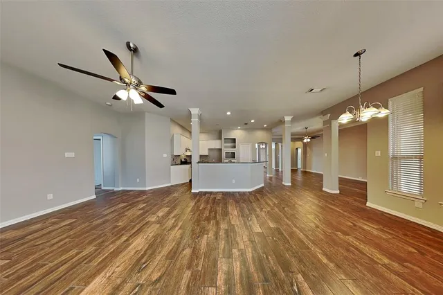 a view of a kitchen with a sink and wooden floor