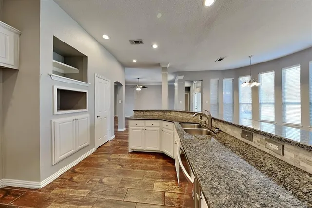 a large white kitchen with a large window