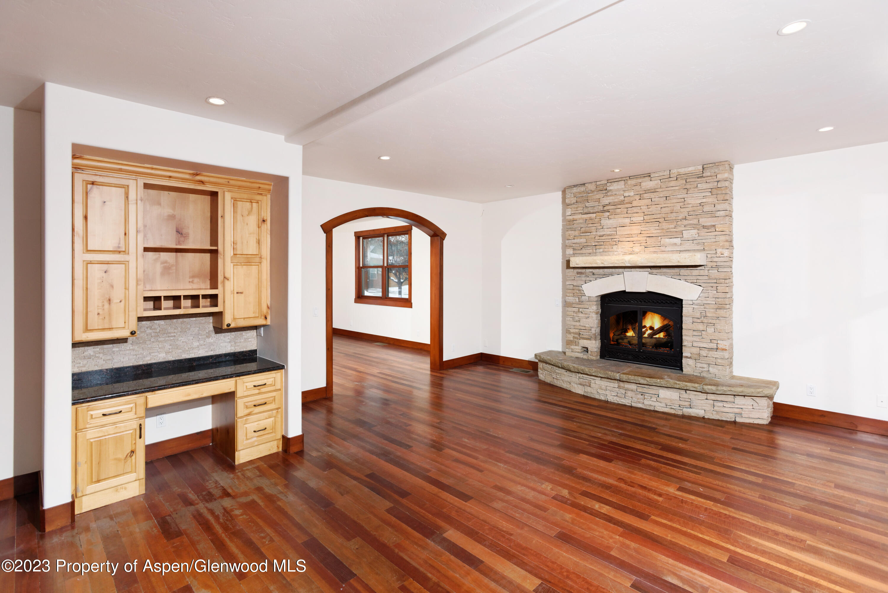 210 Juniper Court Basalt, CO 81621 - Photo 7 of 18 a living room with wooden floors and a fireplace