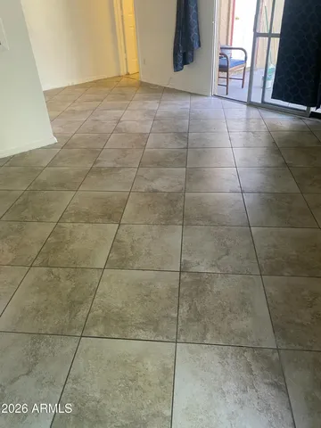 a view of a livingroom with an empty space and a window