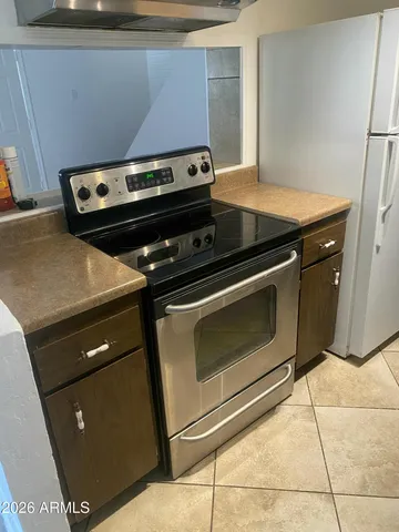 a stove top oven sitting inside of a kitchen