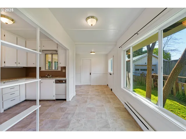 a view of a kitchen with a sink and dishwasher with wooden floor