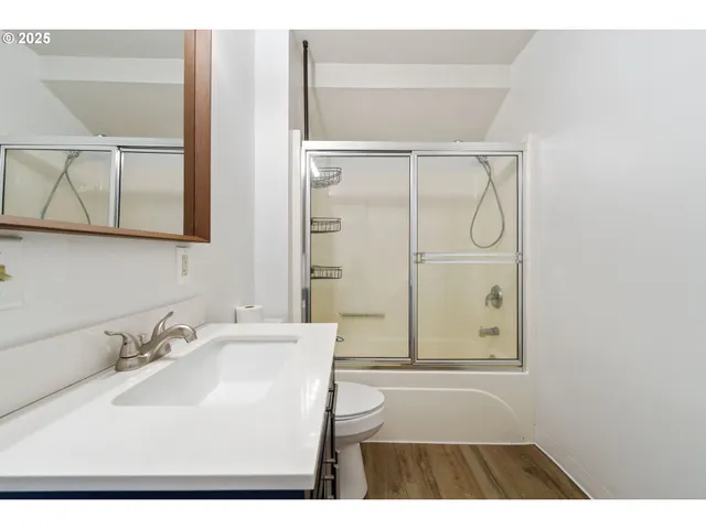 a bathroom with a sink a mirror and a shower