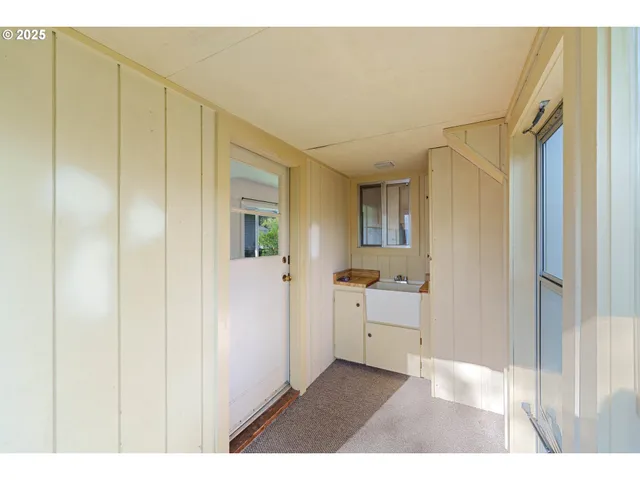 a open bathroom with a shower and a sink