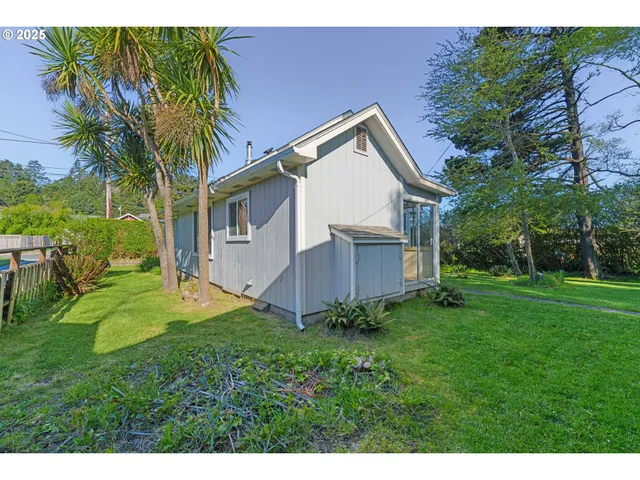 a view of backyard of house with green space