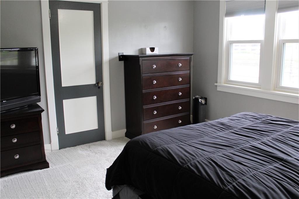 3545 Library Road Pittsburgh, PA 15234 - Photo 14 of 25 a bedroom with a bed and a flat tv screen on dresser