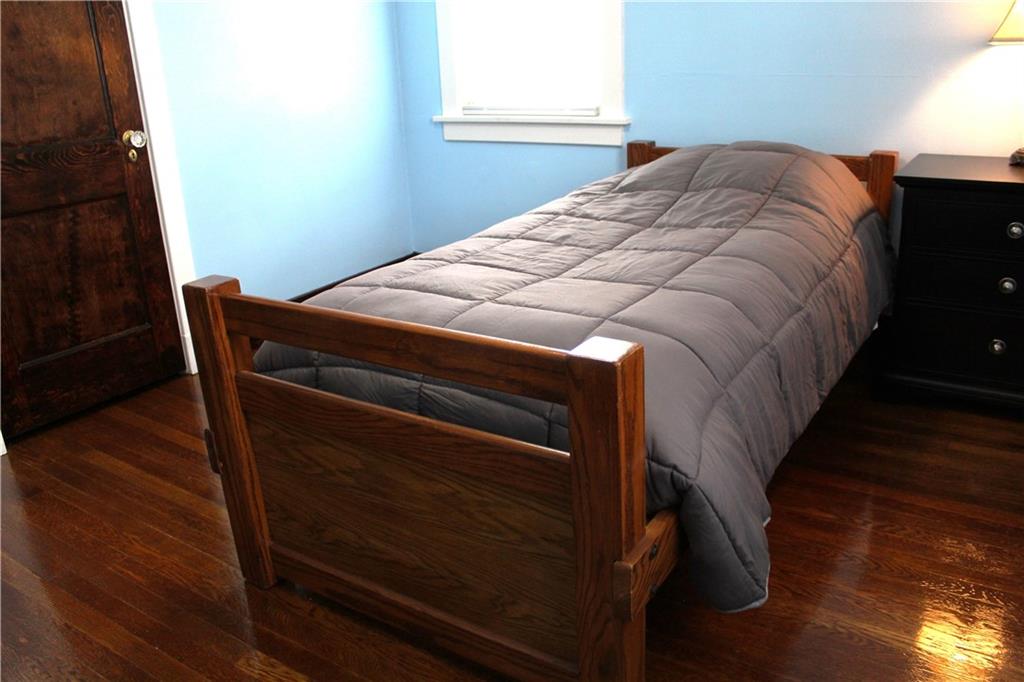 3545 Library Road Pittsburgh, PA 15234 - Photo 19 of 25 a bed sitting in a bedroom next to a window