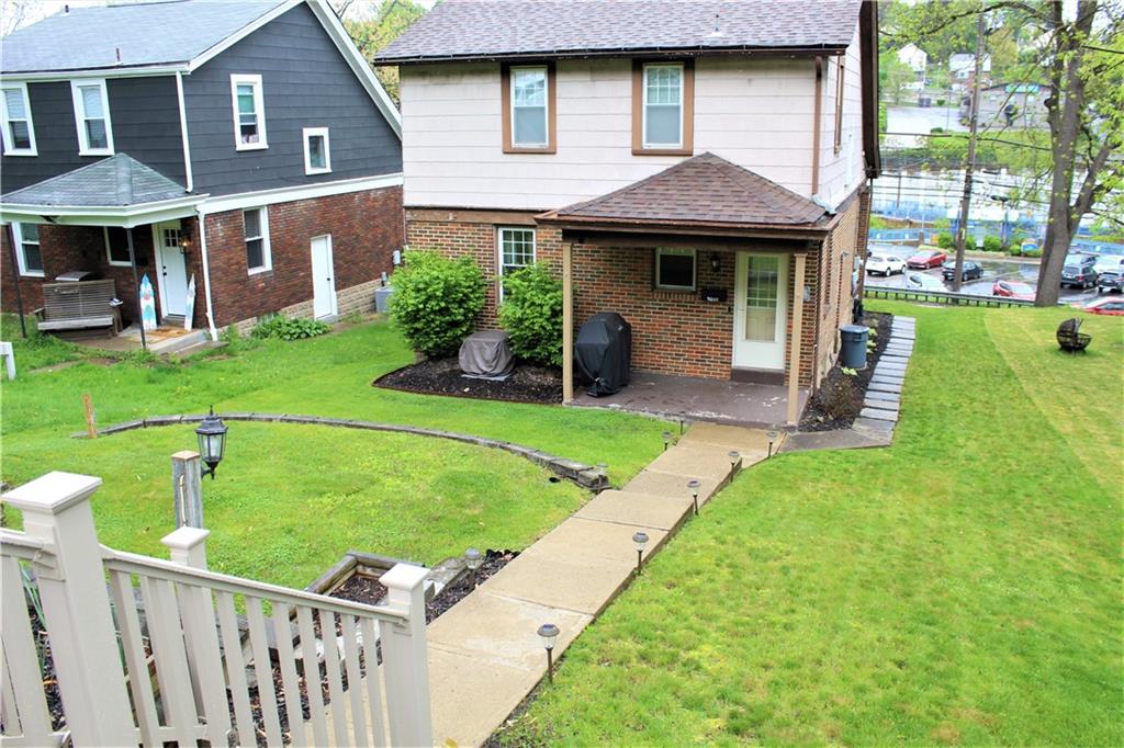 3545 Library Road Pittsburgh, PA 15234 - Photo 24 of 25 a front view of a house with a yard table and chairs