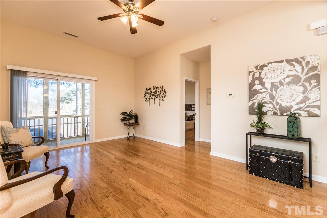 1317 Silver Beach Way Raleigh, NC 27606 - Photo 3 of 24 a view of an empty room with a window and wooden floor