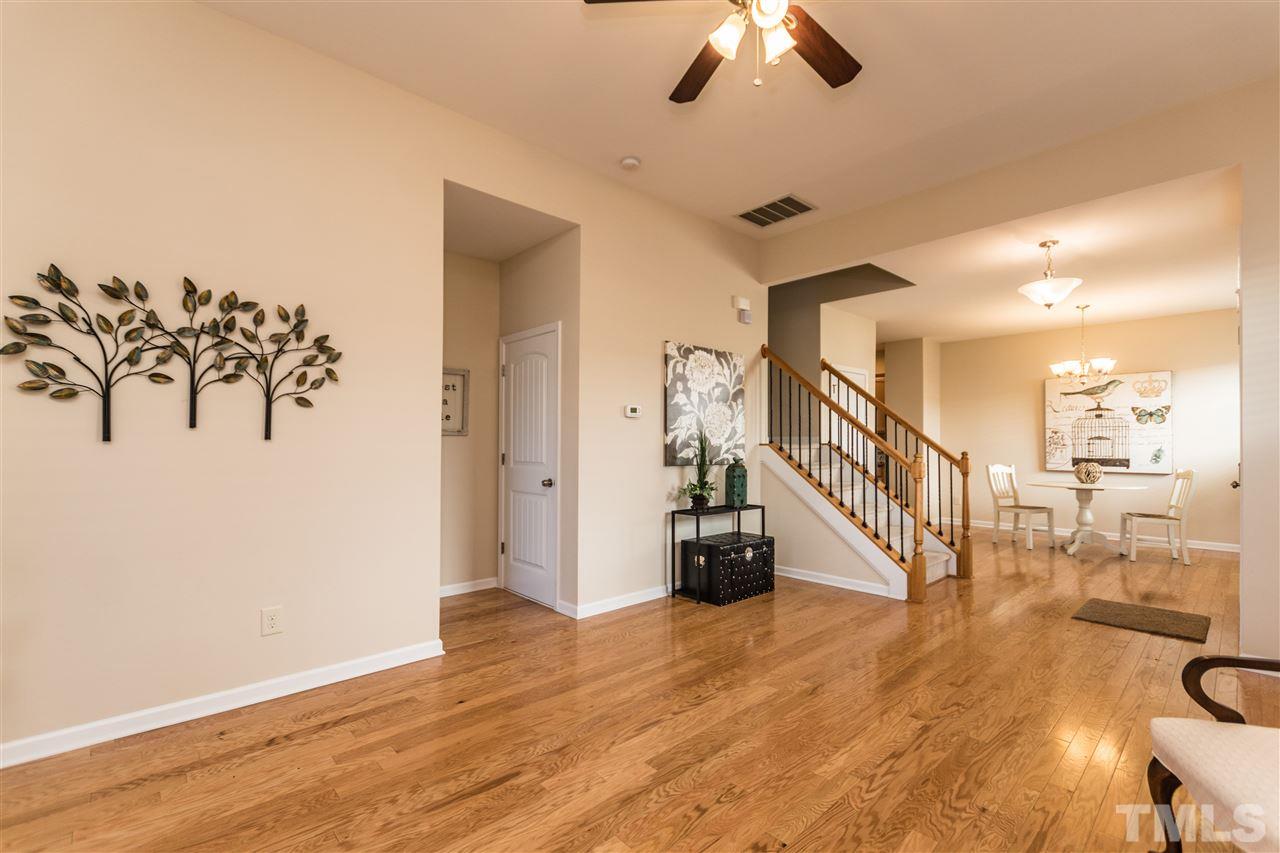 1317 Silver Beach Way Raleigh, NC 27606 - Photo 4 of 24 a view of a room with lots of wooden furniture and a chandelier fan