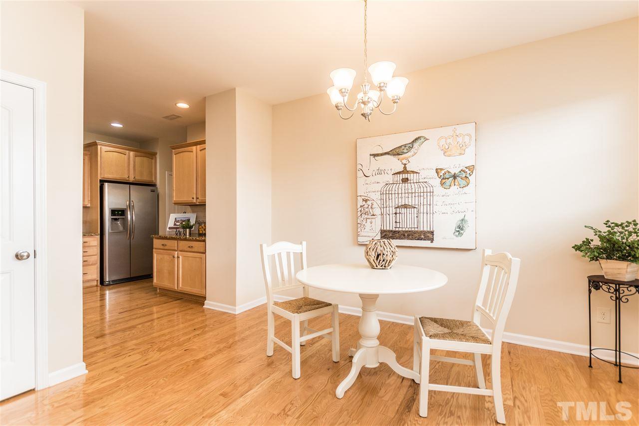 1317 Silver Beach Way Raleigh, NC 27606 - Photo 7 of 24 a view of a dining room with furniture and wooden floor