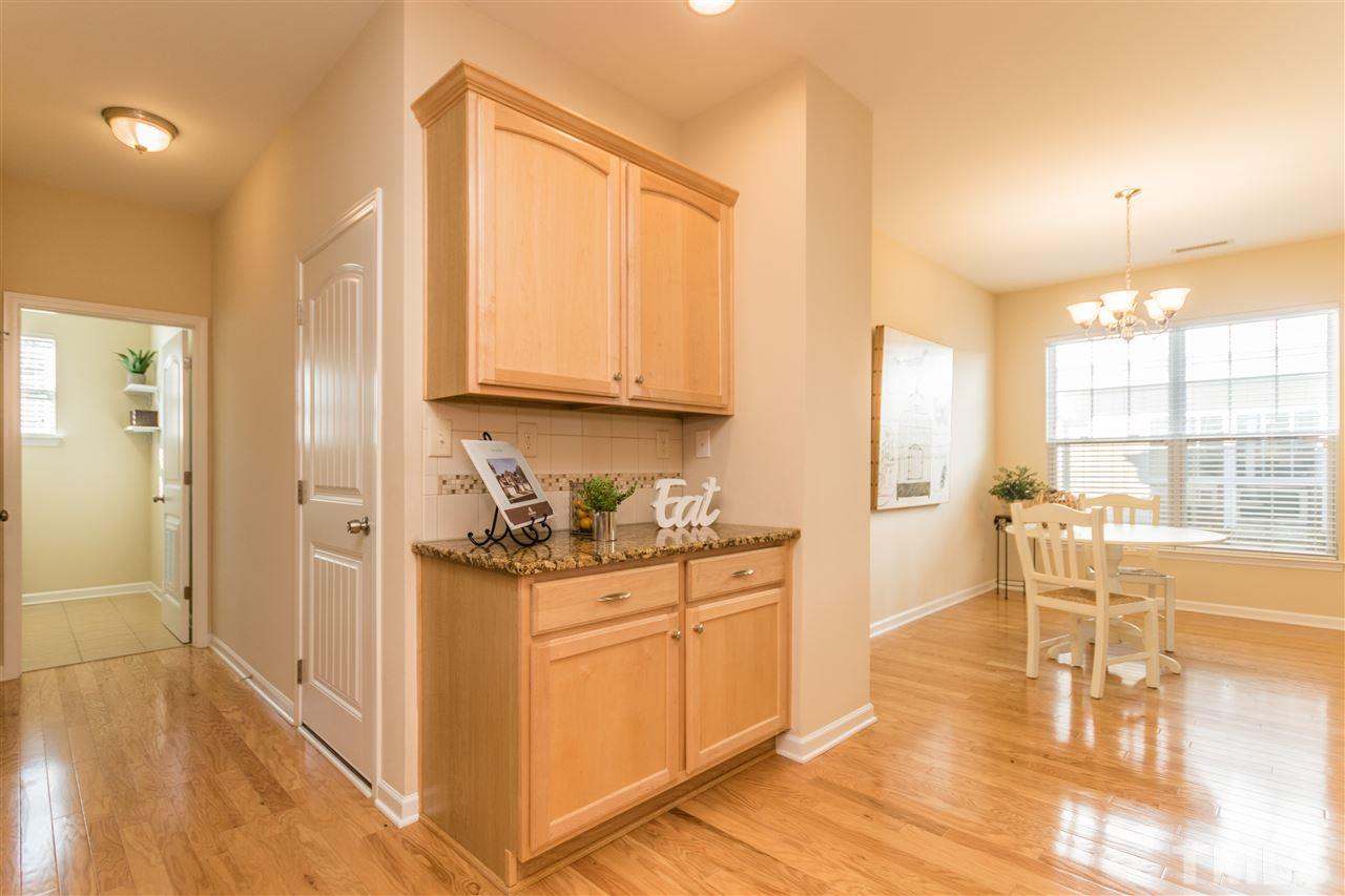 1317 Silver Beach Way Raleigh, NC 27606 - Photo 9 of 24 a view of a kitchen with wooden floor and furniture