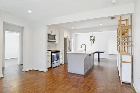 a view of kitchen with furniture and wooden floor