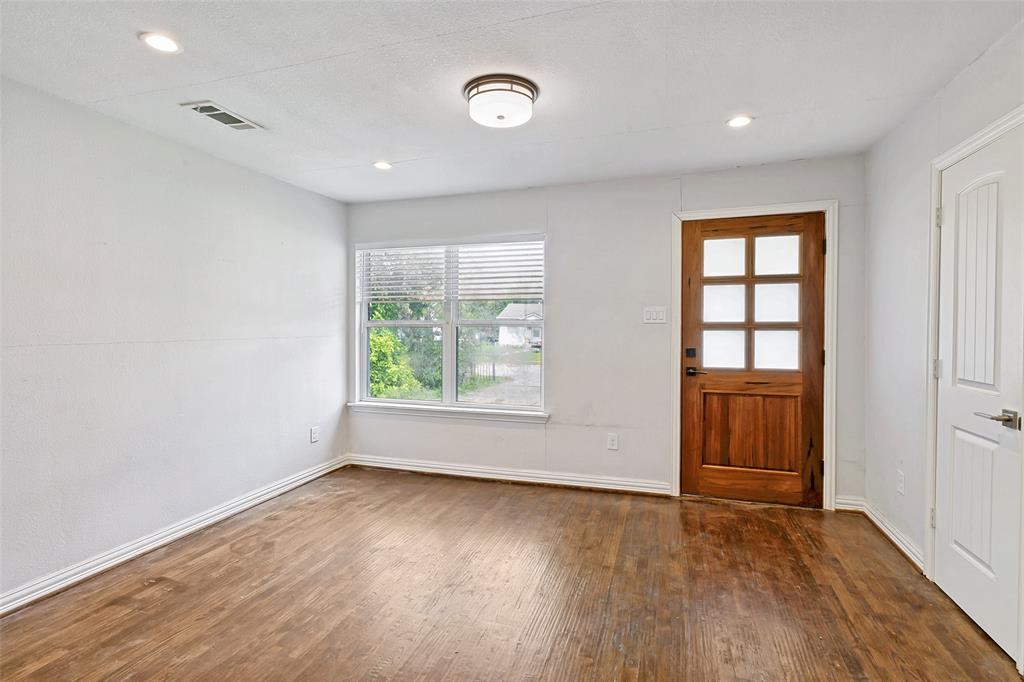 1646 BriarCliff Road Dallas, TX 75235 - Photo 2 of 32 an empty room with wooden floor and windows