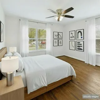 a bedroom with a large bed and a window