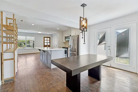 a view of kitchen and dining room with wooden floor