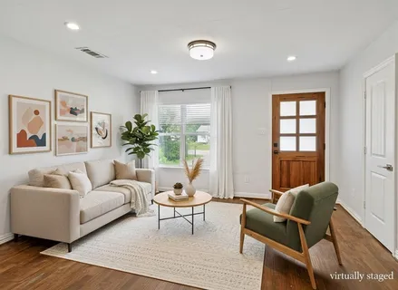 a living room with furniture and wooden floor