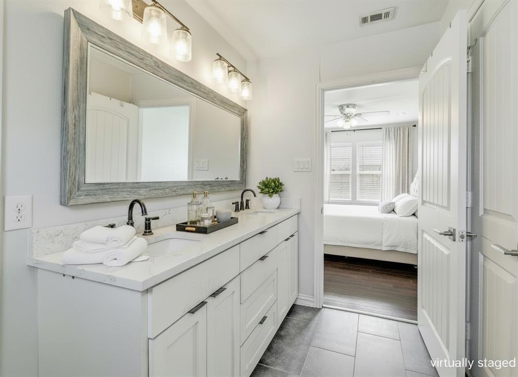 1646 BriarCliff Road Dallas, TX 75235 - Photo 6 of 32 a bathroom with a sink a vanity and a mirror