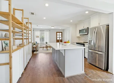 a kitchen with stainless steel appliances a refrigerator and a stove top oven