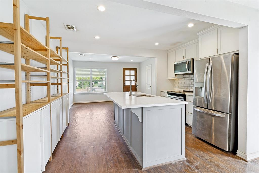 1646 BriarCliff Road Dallas, TX 75235 - Photo 8 of 32 a kitchen with kitchen island wooden floors appliances and center island