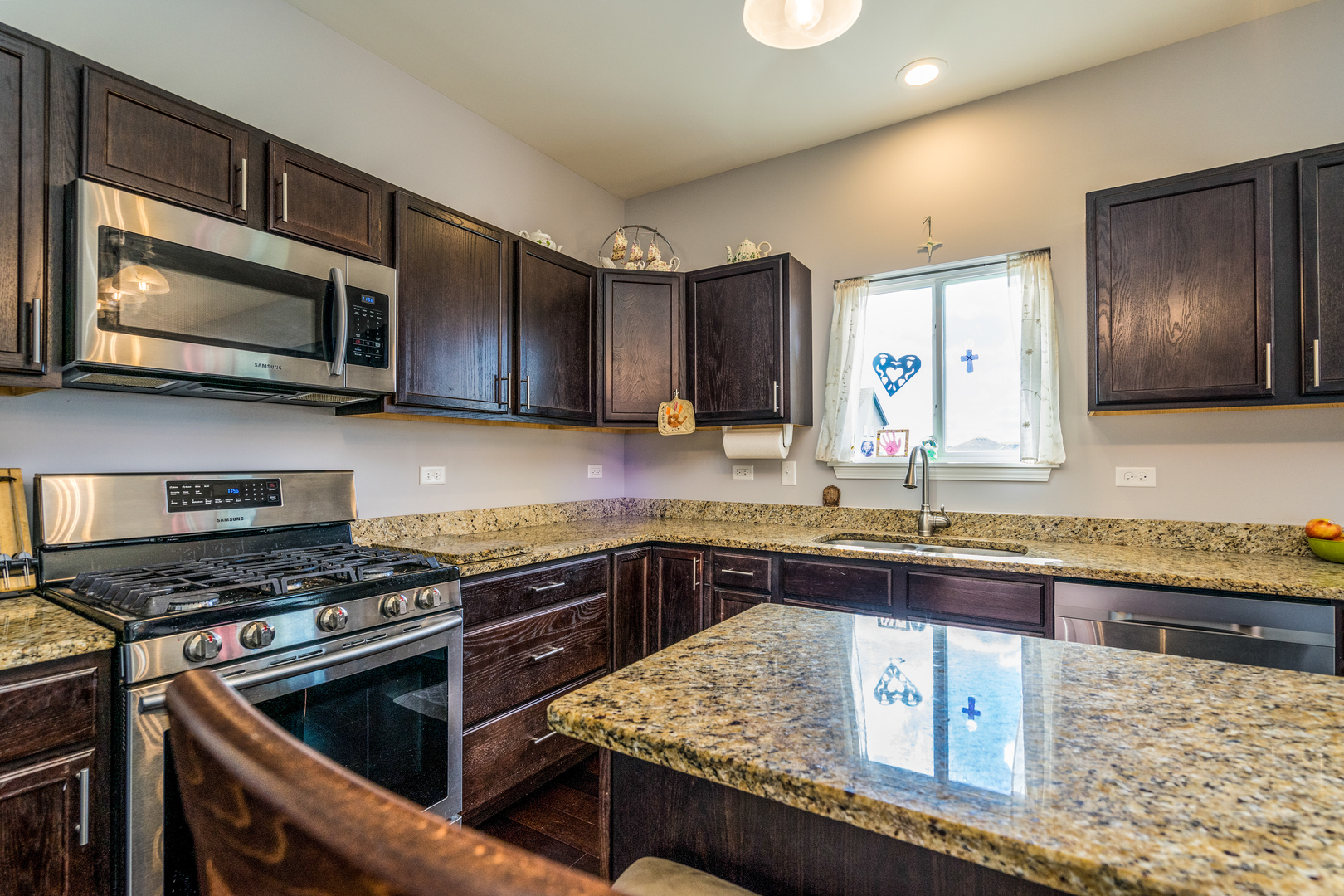 1604 Edentenny Road New Lenox, IL 60451 - Photo 5 of 37 a kitchen with stainless steel appliances granite countertop a stove microwave and sink