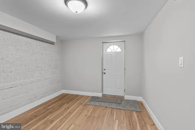 a view of room with window and wooden floor