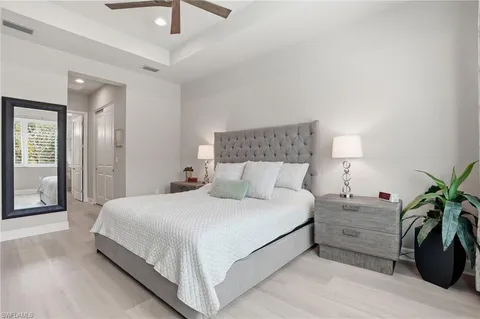 a bedroom with a bed and a potted plant