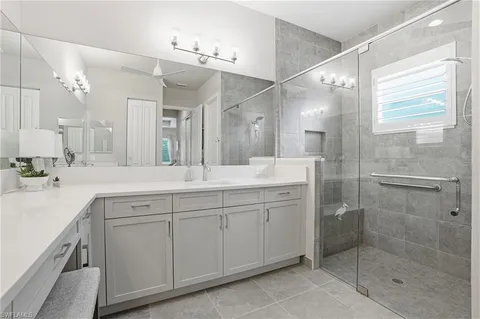 a spacious bathroom with a shower sink and mirror