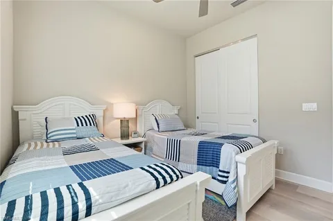 a bedroom with a two beds and a window