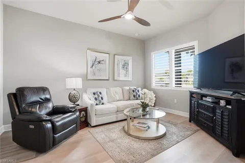 a living room with furniture a window and a flat screen tv