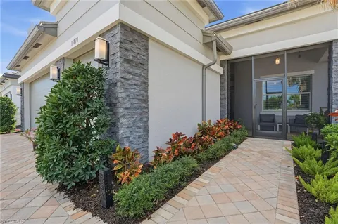 a front view of a house having flowers