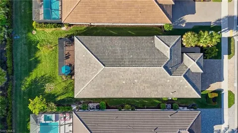 an aerial view of a house with a big yard