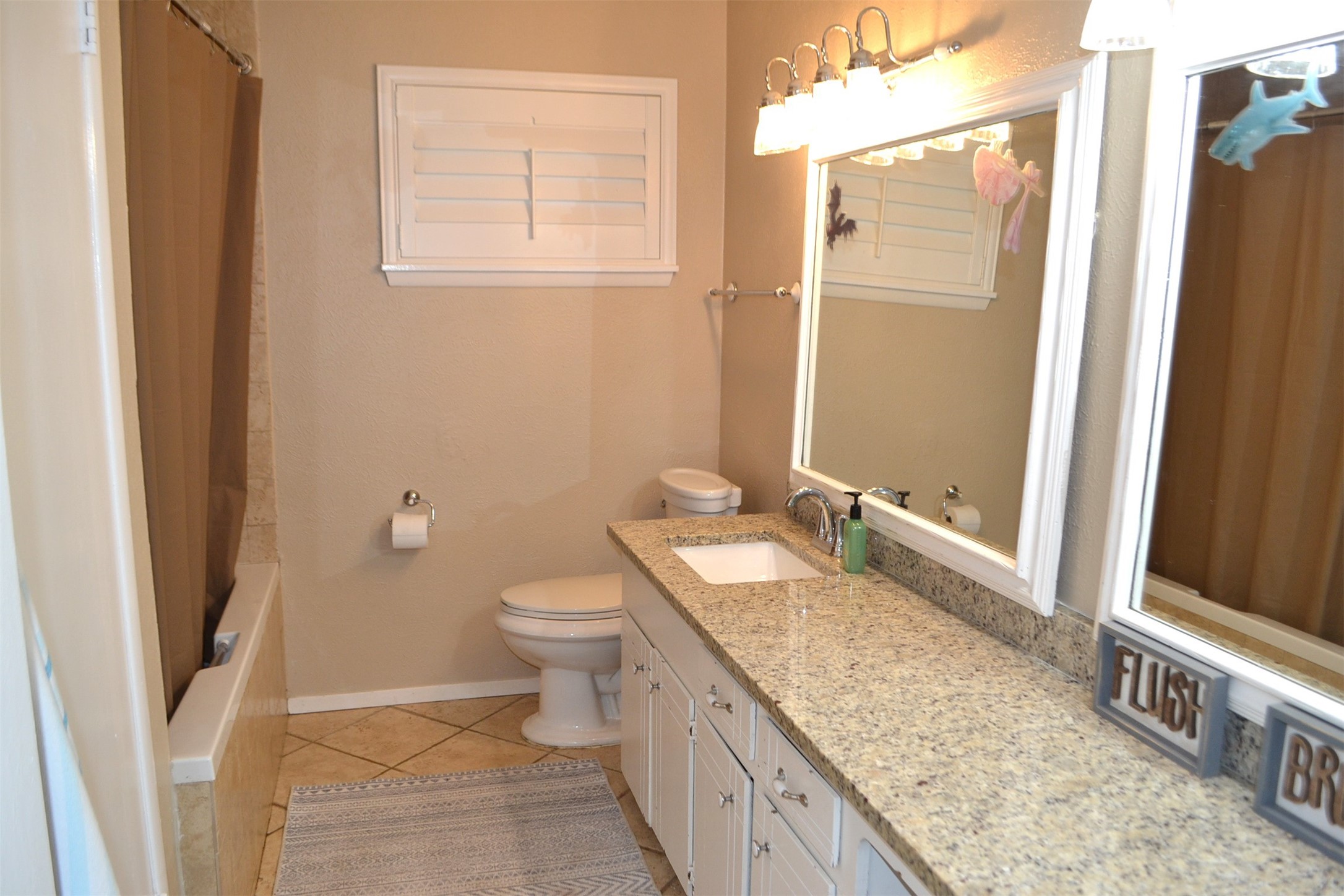 610 East X Street Deer Park, TX 77536 - Photo 27 of 44 a bathroom with a granite countertop sink and a mirror