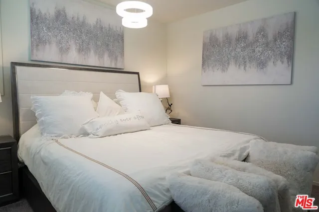 a bedroom with bed and window