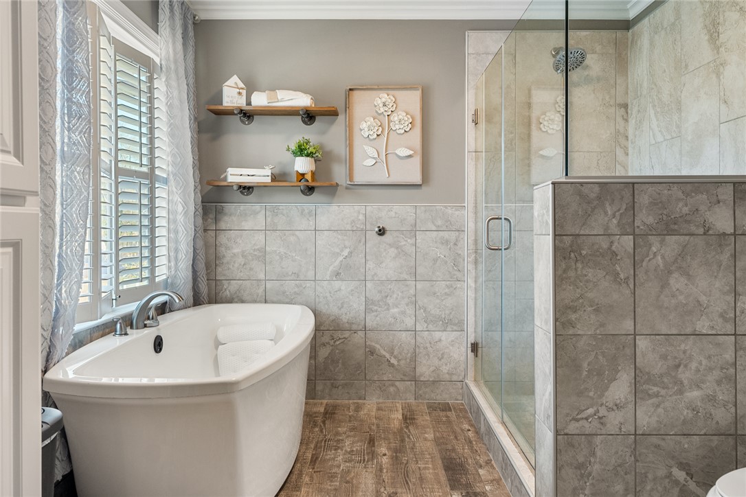 112 C-10-220 Anderson, SC 29621 - Photo 28 of 45 This serene bathroom offers a soaking tub and a spacious walk-in shower for ultimate relaxation.