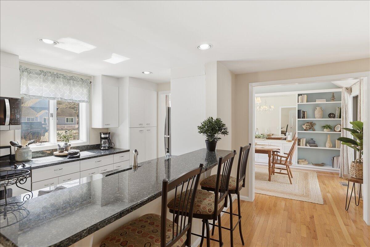 100 Mid-Iron Way, Unit 7027 Mashpee, MA 02649 - Photo 6 of 38 a view of a dining room with furniture and wooden floor