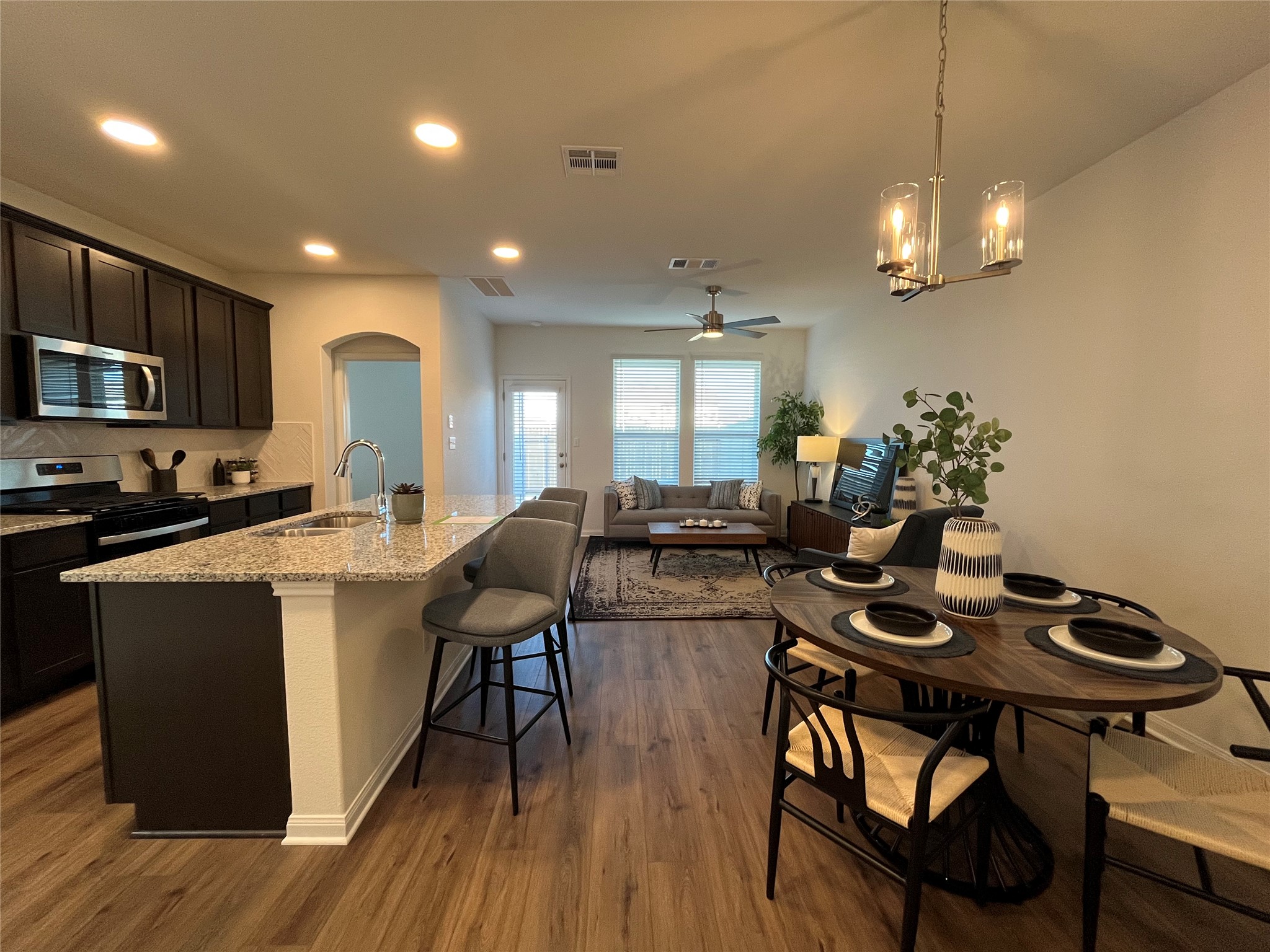 8522 Wellspring Loop Round Rock, TX 78665 - Photo 1 of 37 Family, dining, kitchen. For demonstration purposes only. This will be the same interior layout. Colors can vary.