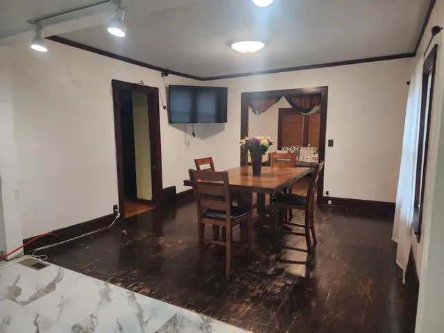 a dining room with furniture and a wooden floor