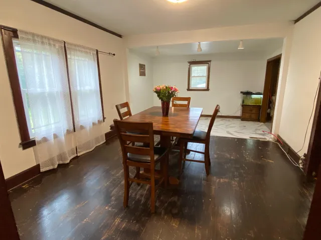 a dining room with furniture and wooden floor