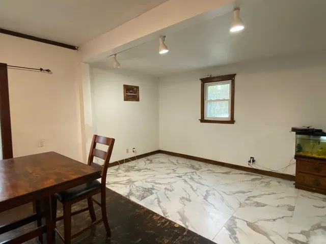 a view of a dining room with a table and chairs